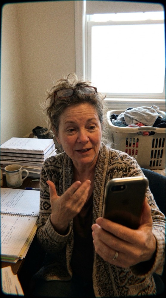 A coach talking to camera in her office